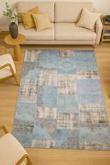 Living room with a patchwork rug, beige sofa, and wooden furniture.