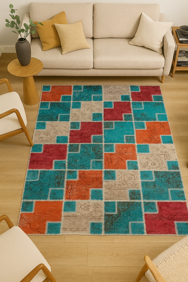 Colorful geometric-patterned rug on a wooden floor with a beige sofa and chairs in a living room setting.